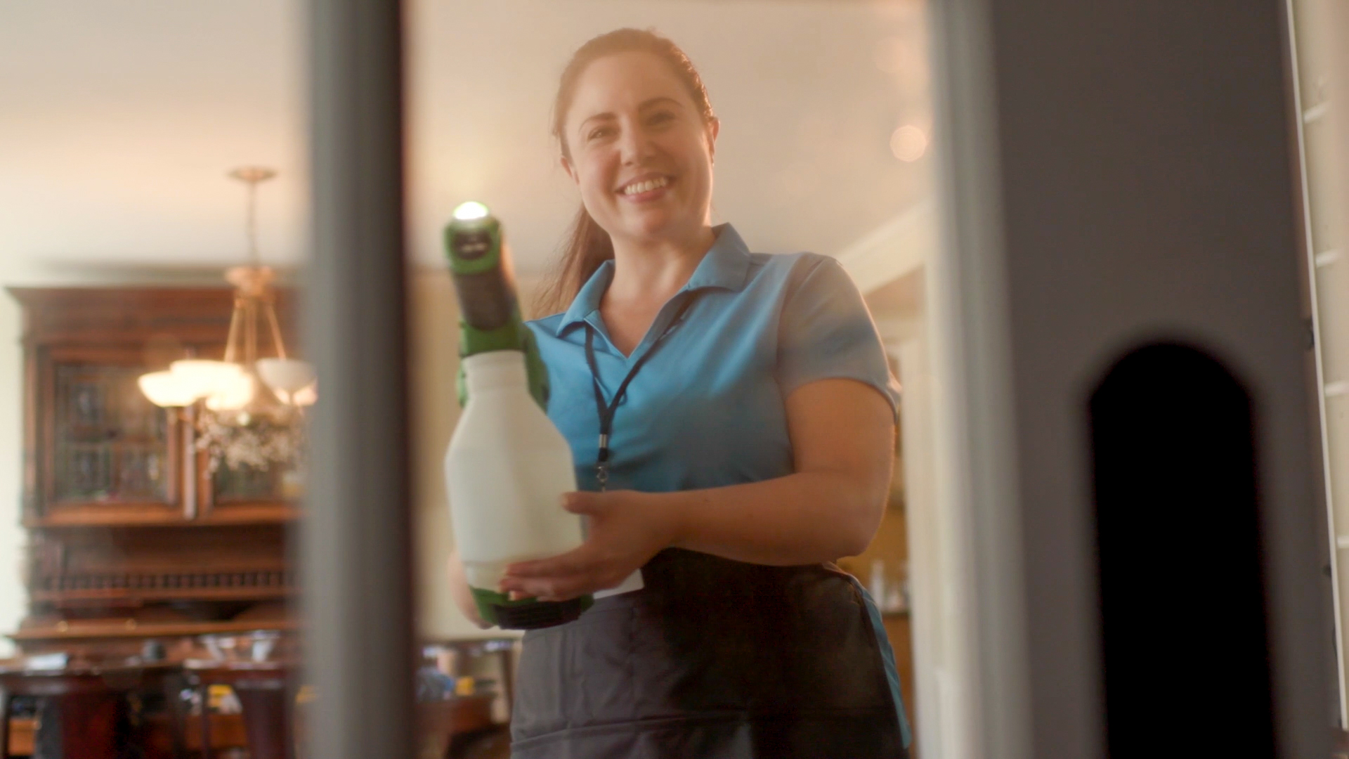 Maid Brigade cleaner using professional equipment during a home cleaning